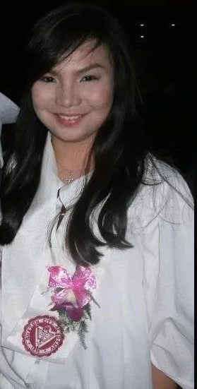 In a school uniform, with a corsage